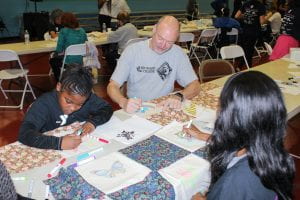 BC President J. David Armstrong, Jr. colors a picture for MLK Day